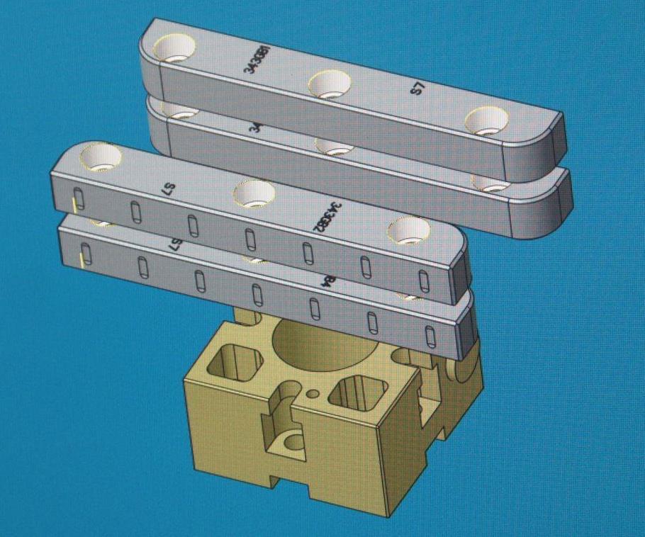 All parts are modeled in CAD/CAM software along with representations of the pallet, and all references are calculated according to the geometry of a custom tooling ball. In this case, Omega is making the most of its material by machining multiple gibs (components for mold slide assemblies) from the same block. The pallet shown here is a 54-mm model from System 3R.