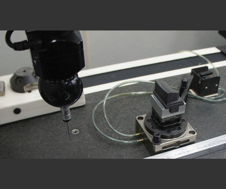 Precisely repeatable fixturing enables seamlessly incorporating machines not tended by the robot into the process flow, including wire EDM units and, as shown here, the toolroom CMM.