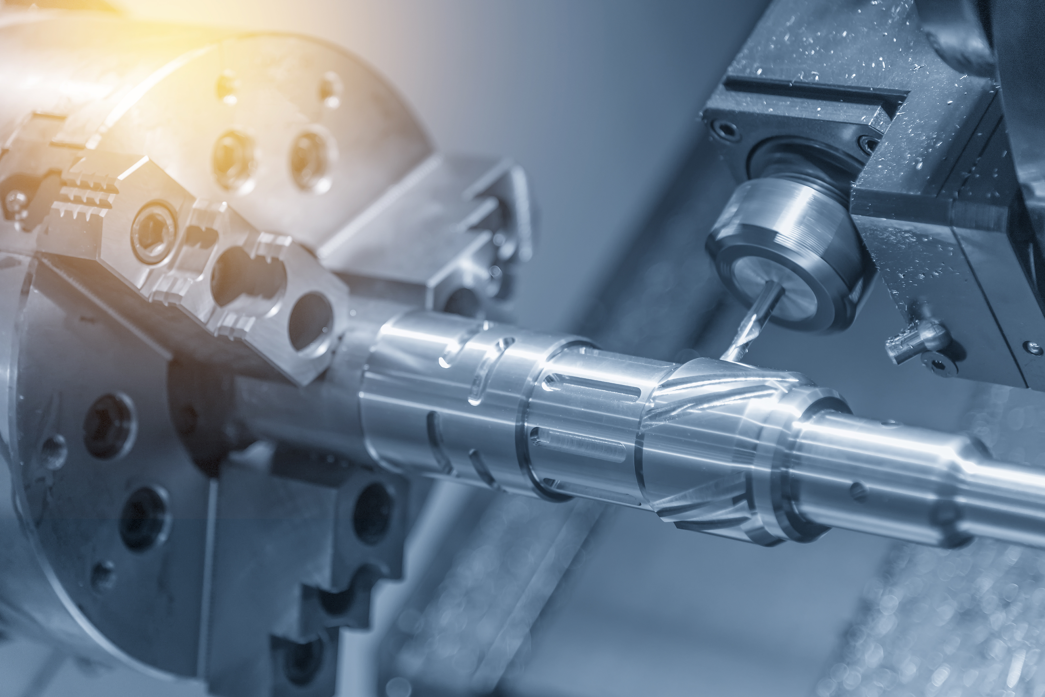 The CNC lathe machine cutting the slot at the shaft by milling spindle