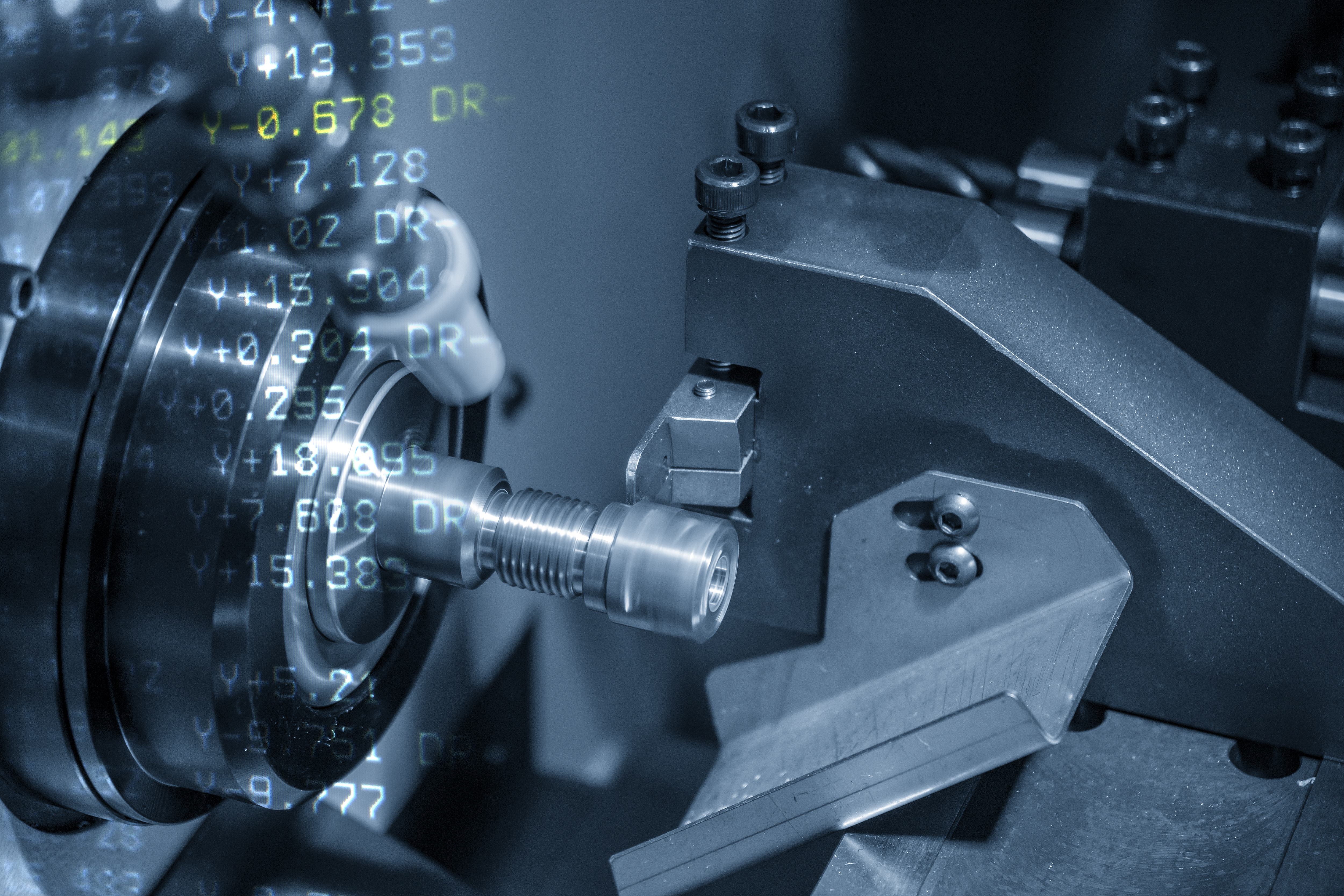 The abstract scene of CNC lathe machine  cutting  the thread  at the metal shaft with the G-code data background.Hi-technology parts manufacturing process by turning machine.